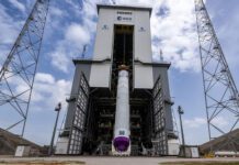 The first integrated Ariane 6 central core has been lifted to the vertical position atop its launch pad ahead of its maiden flight.