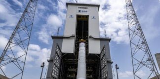 The first integrated Ariane 6 central core has been lifted to the vertical position atop its launch pad ahead of its maiden flight.